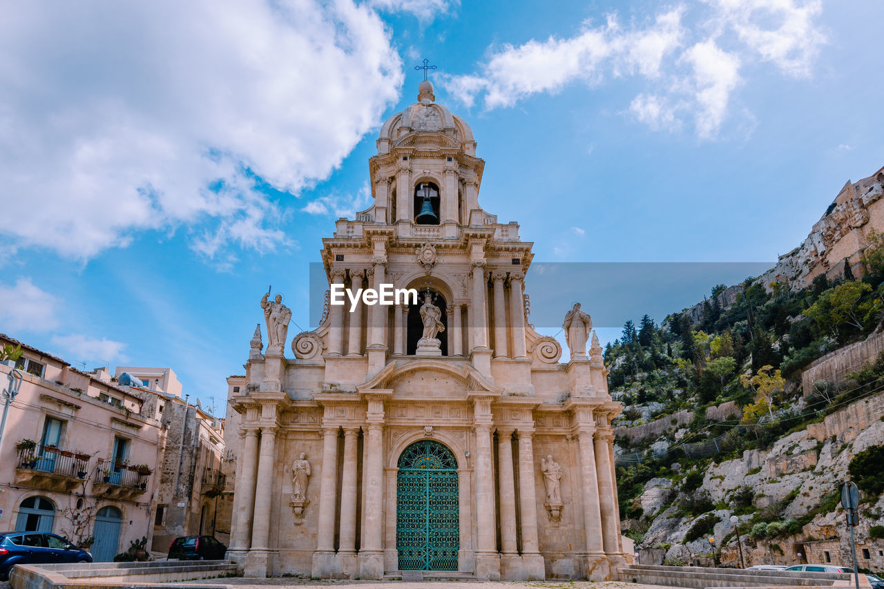 Church facade church of san bartolomeo in scicli with blue sky and white clouds