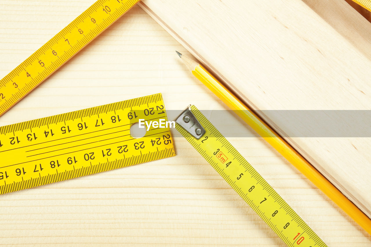 High angle view of tape measure and ruler on table