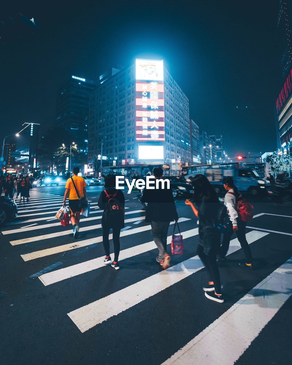 GROUP OF PEOPLE WALKING ON CITY STREET