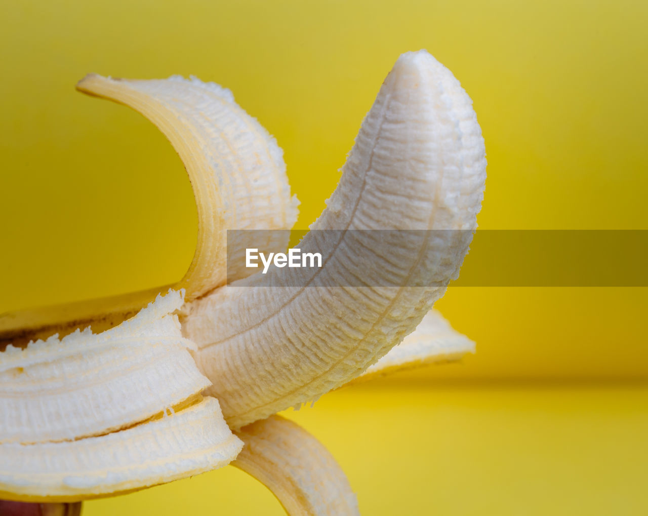 Close-up of banana against yellow background