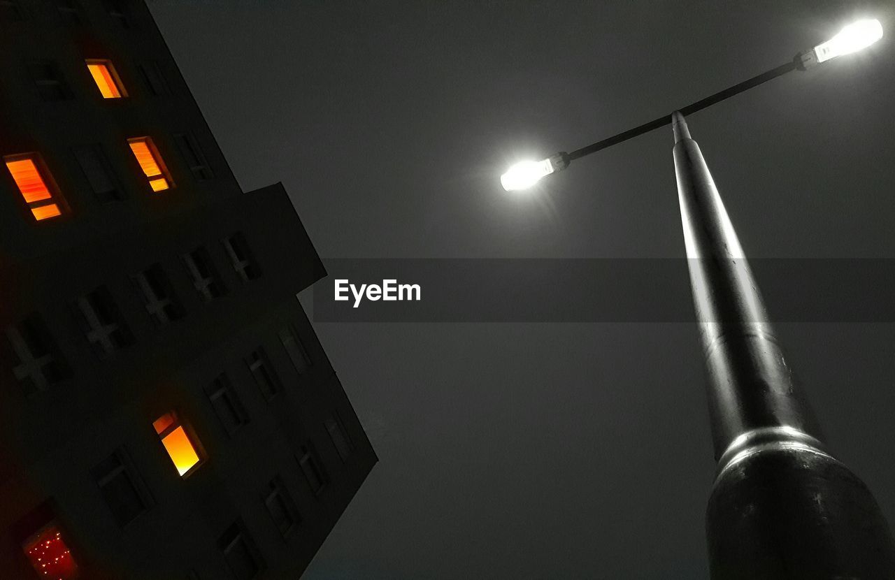 Low angle view of illuminated street light against sky at night