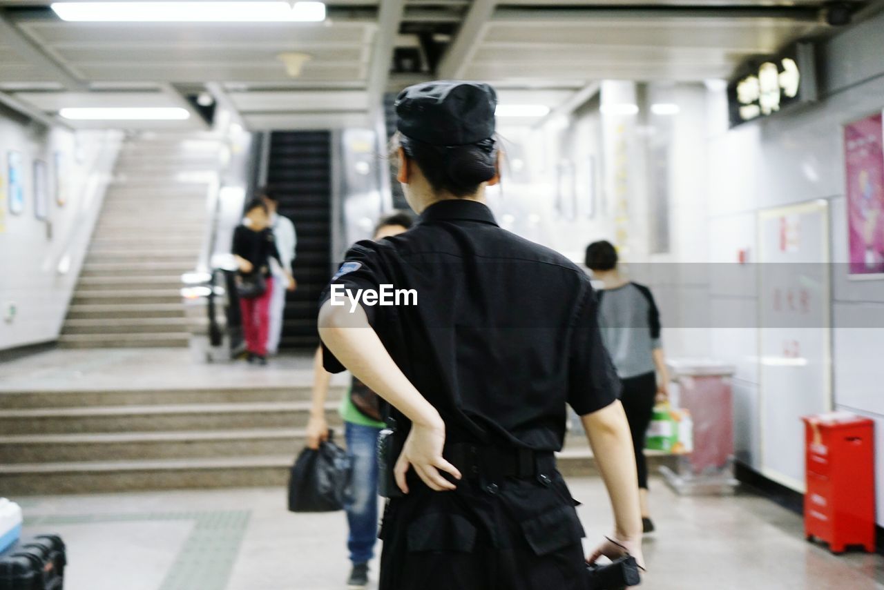 Rear view of security guard at subway station