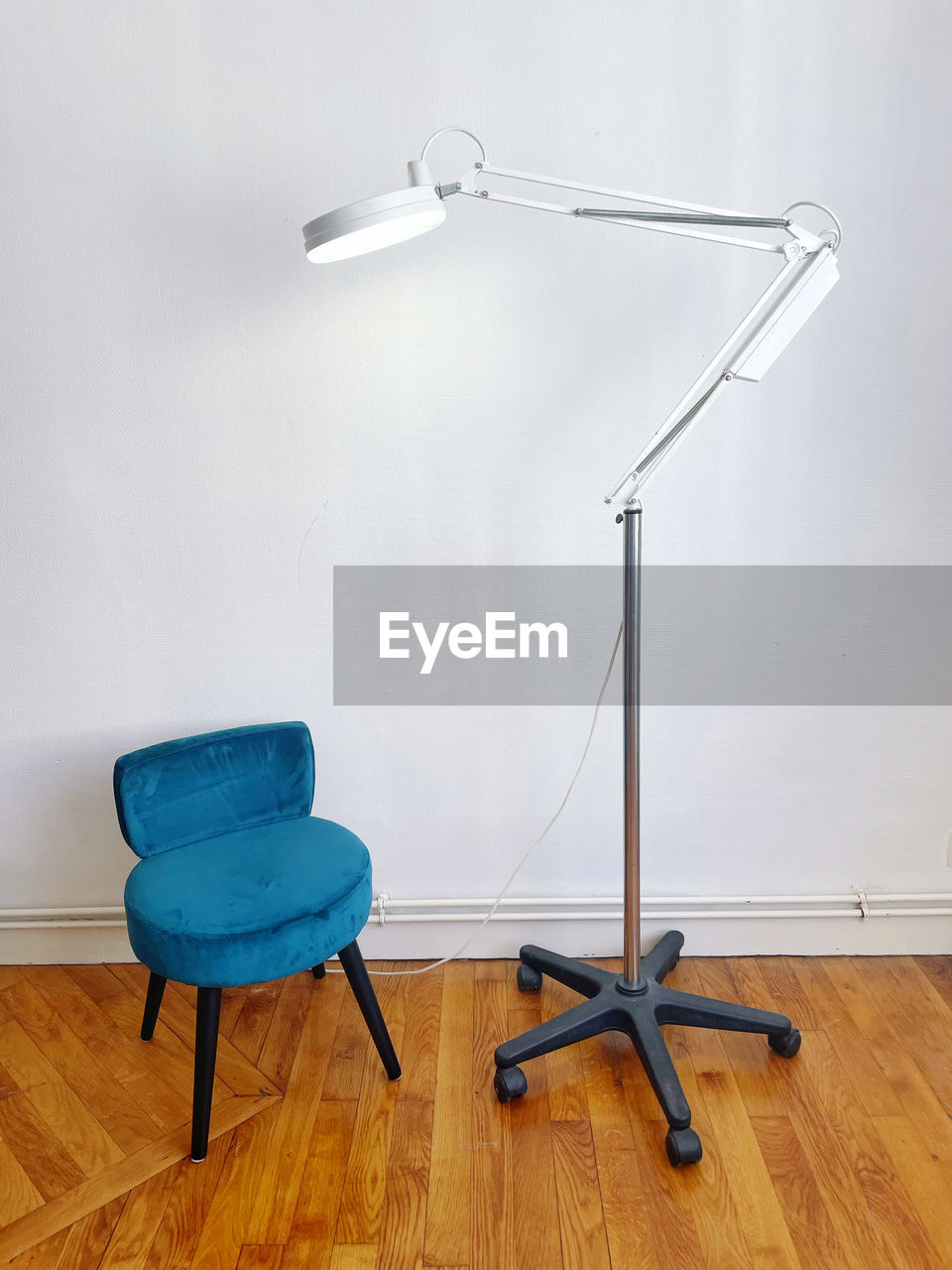 Empty chair and lamppost on a wooden floor room 