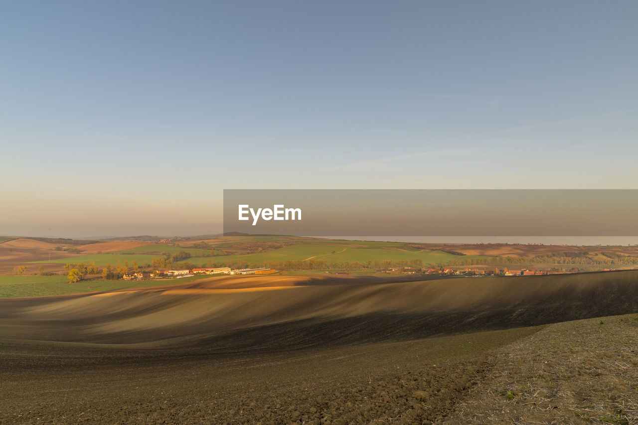 SCENIC VIEW OF LANDSCAPE AGAINST SKY AT SUNSET