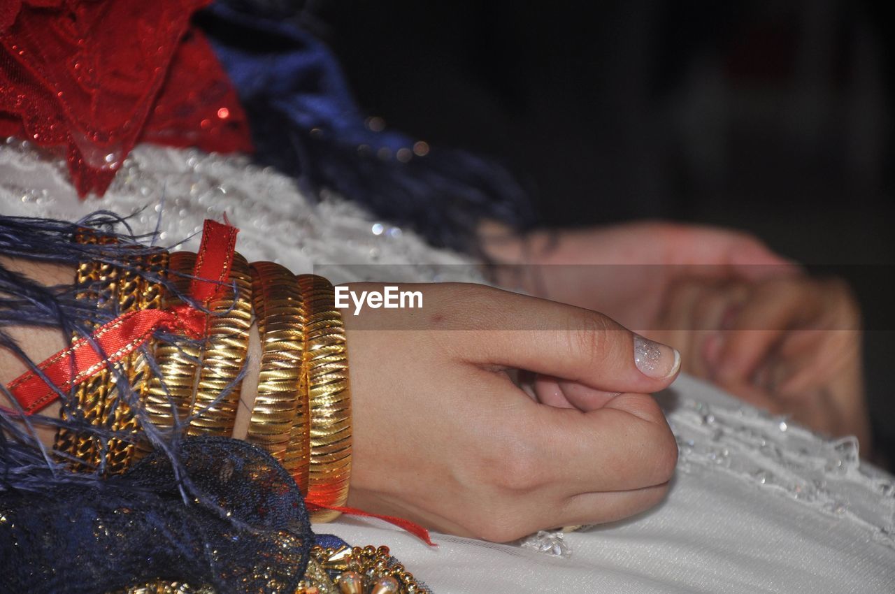 hand, jewelry, adult, bracelet, one person, women, clothing, bangle, midsection, close-up, ring, traditional clothing, focus on foreground, celebration, wedding, tradition, indoors, pattern, henna, ceremony, arts culture and entertainment, event, life events, newlywed, bride, fashion accessory, fashion, wedding ceremony, henna tattoo, lifestyles, religion