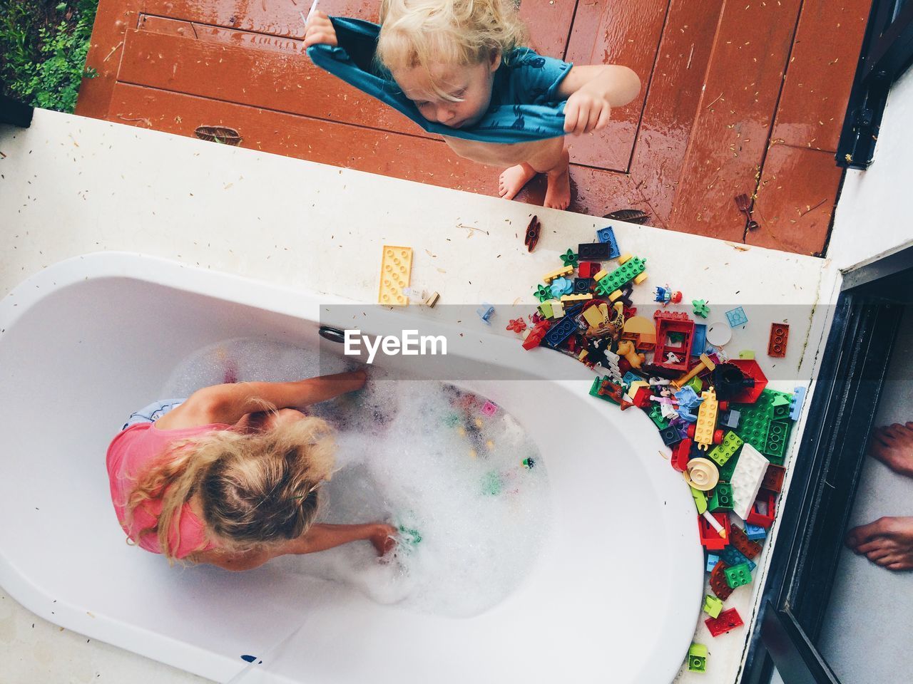 childhood, real people, child, bathtub, leisure activity, high angle view, lifestyles, people, domestic bathroom, indoors, water, domestic room, bathroom, directly above, women, boys, home, men, messy, innocence