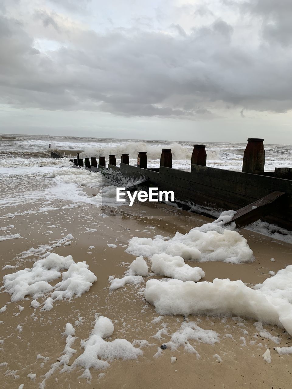 SNOW ON SEA SHORE AGAINST SKY