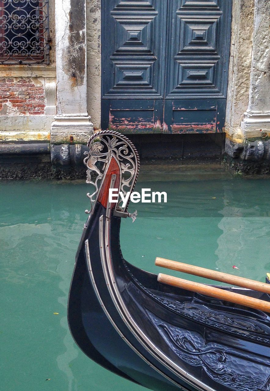 Cropped image of gondola sailing on grand canal against old building