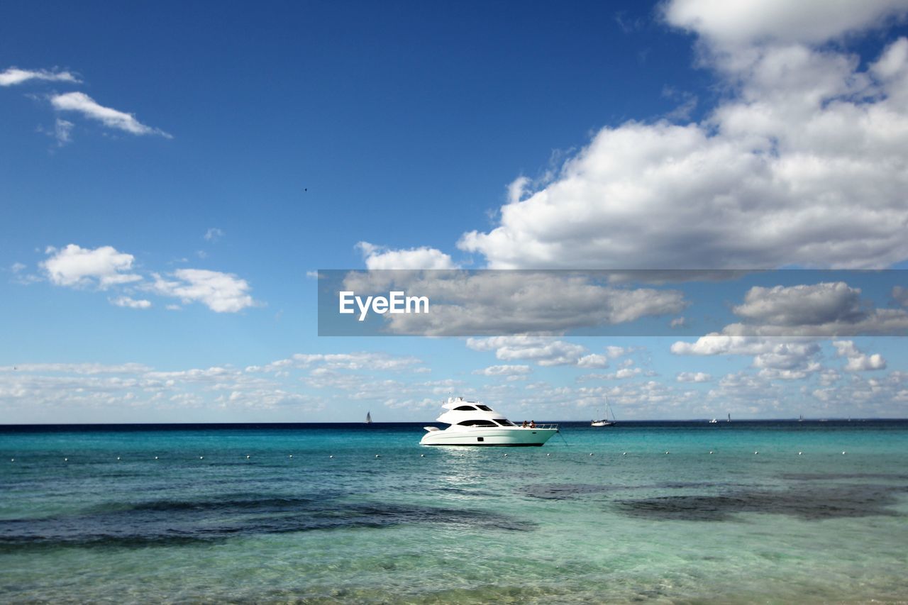 NAUTICAL VESSEL SAILING IN SEA AGAINST SKY