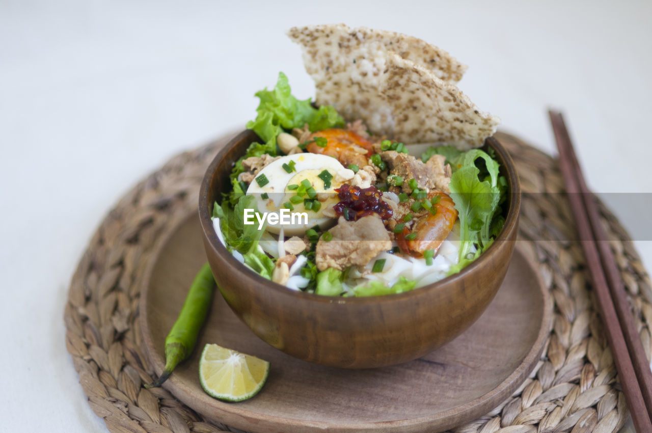 Vietnamese noodle - my quang, vietnamese traditional cuisine, noodles in bowl on the table 