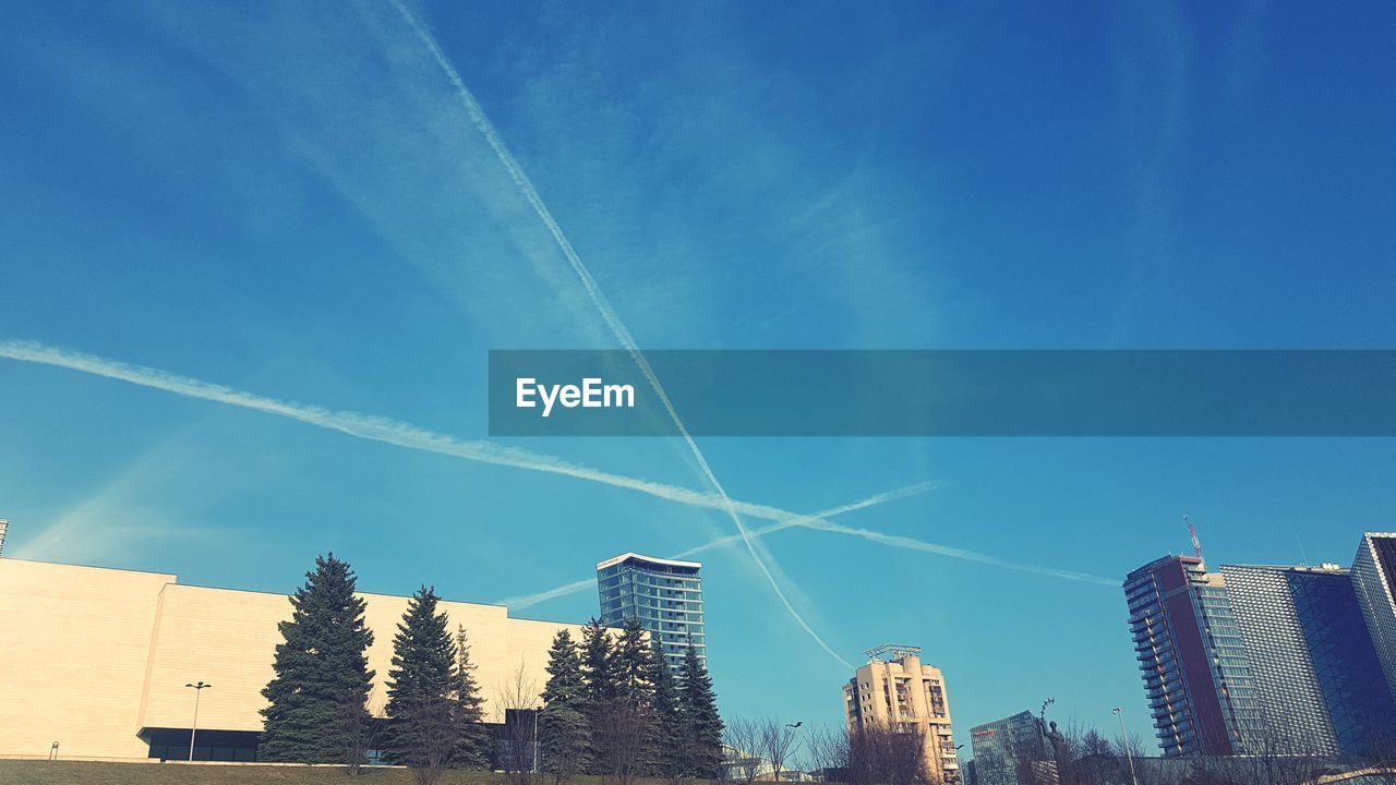 LOW ANGLE VIEW OF VAPOR TRAILS IN SKY