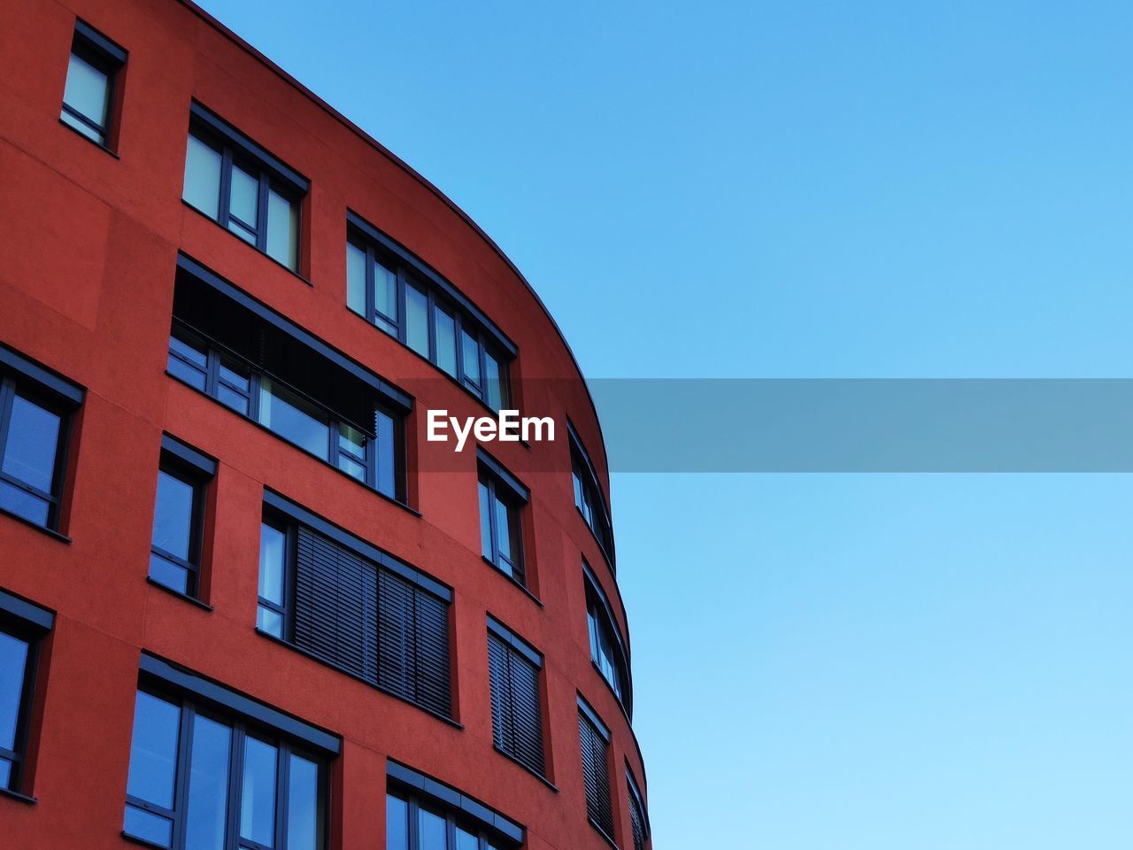 Low angle view of building against clear blue sky