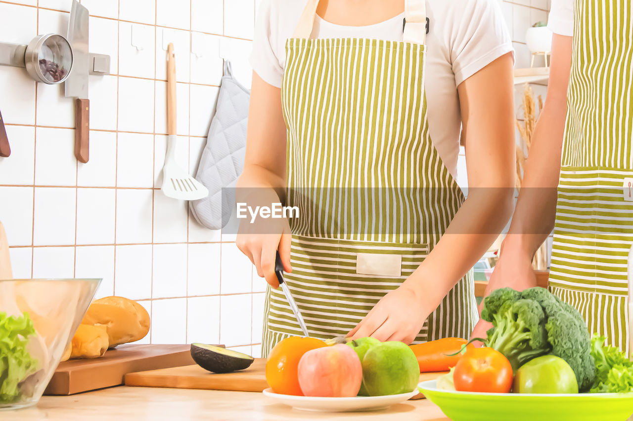 midsection of woman preparing food at table