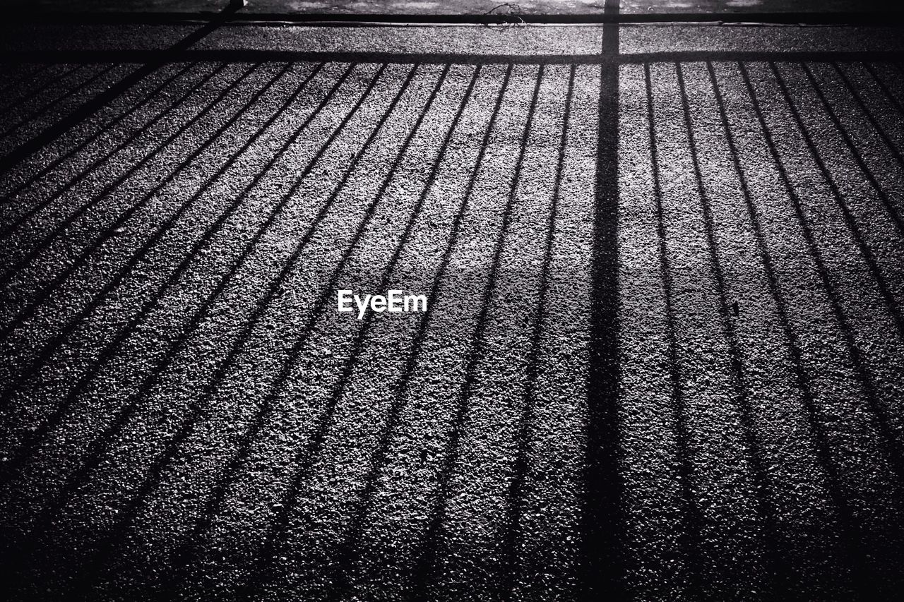 Shadow of metal grate on street