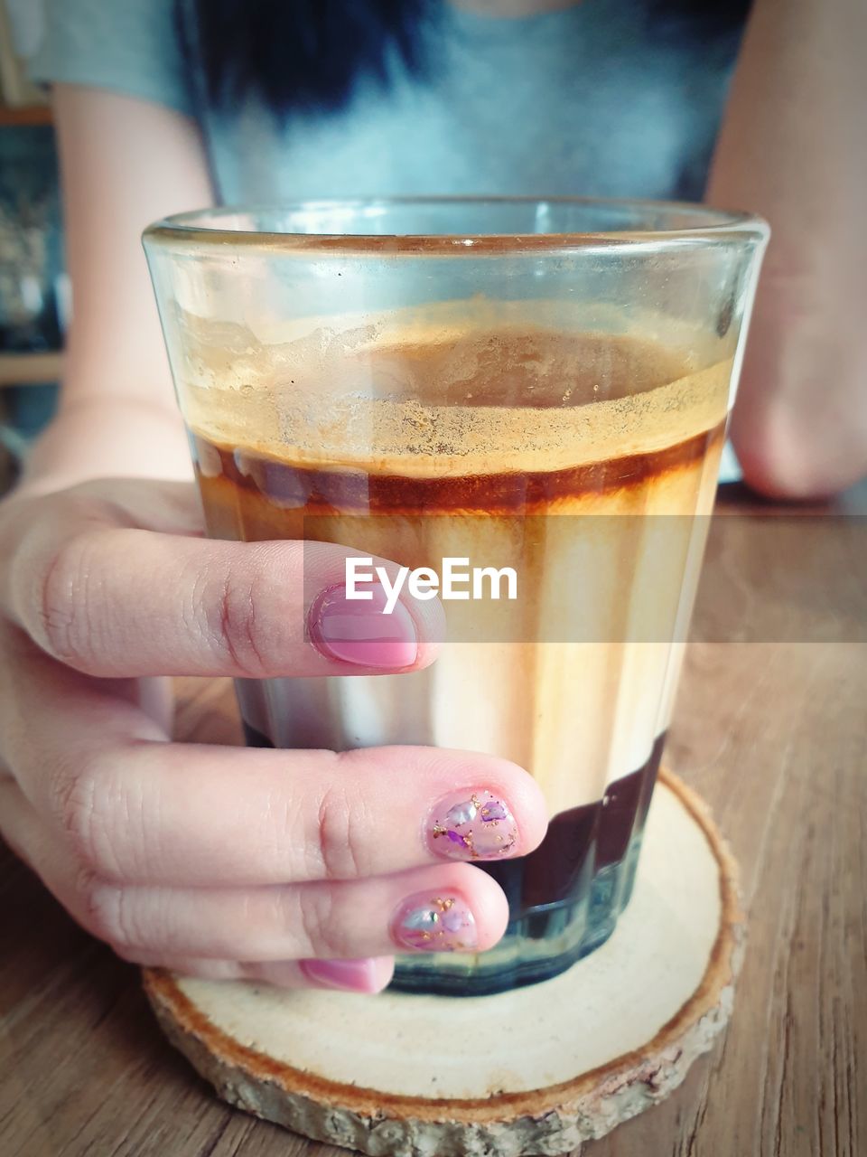 MIDSECTION OF WOMAN HOLDING GLASS OF JUICE