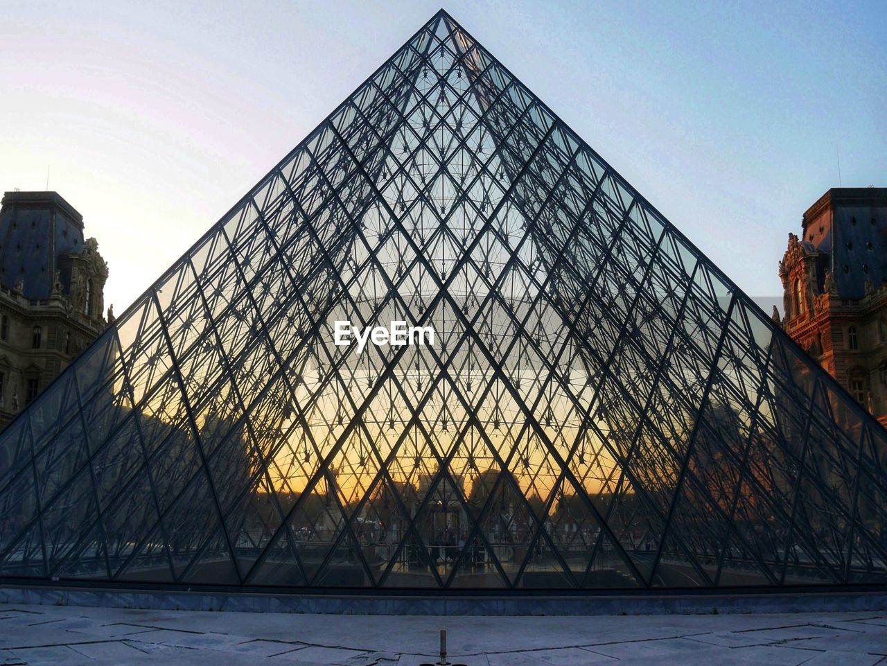 LOW ANGLE VIEW OF BUILDING AGAINST SKY DURING SUNSET