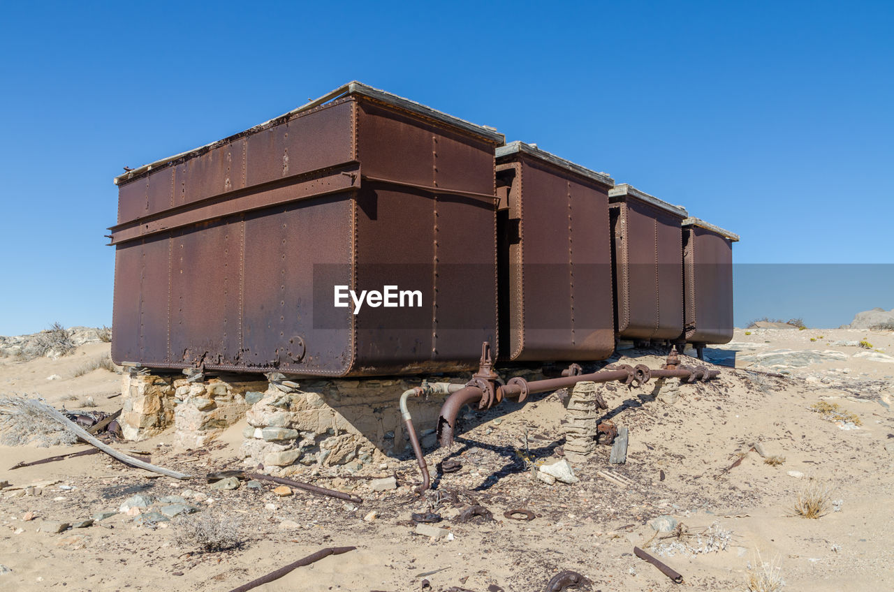 Abandoned storage tanks against clear sky