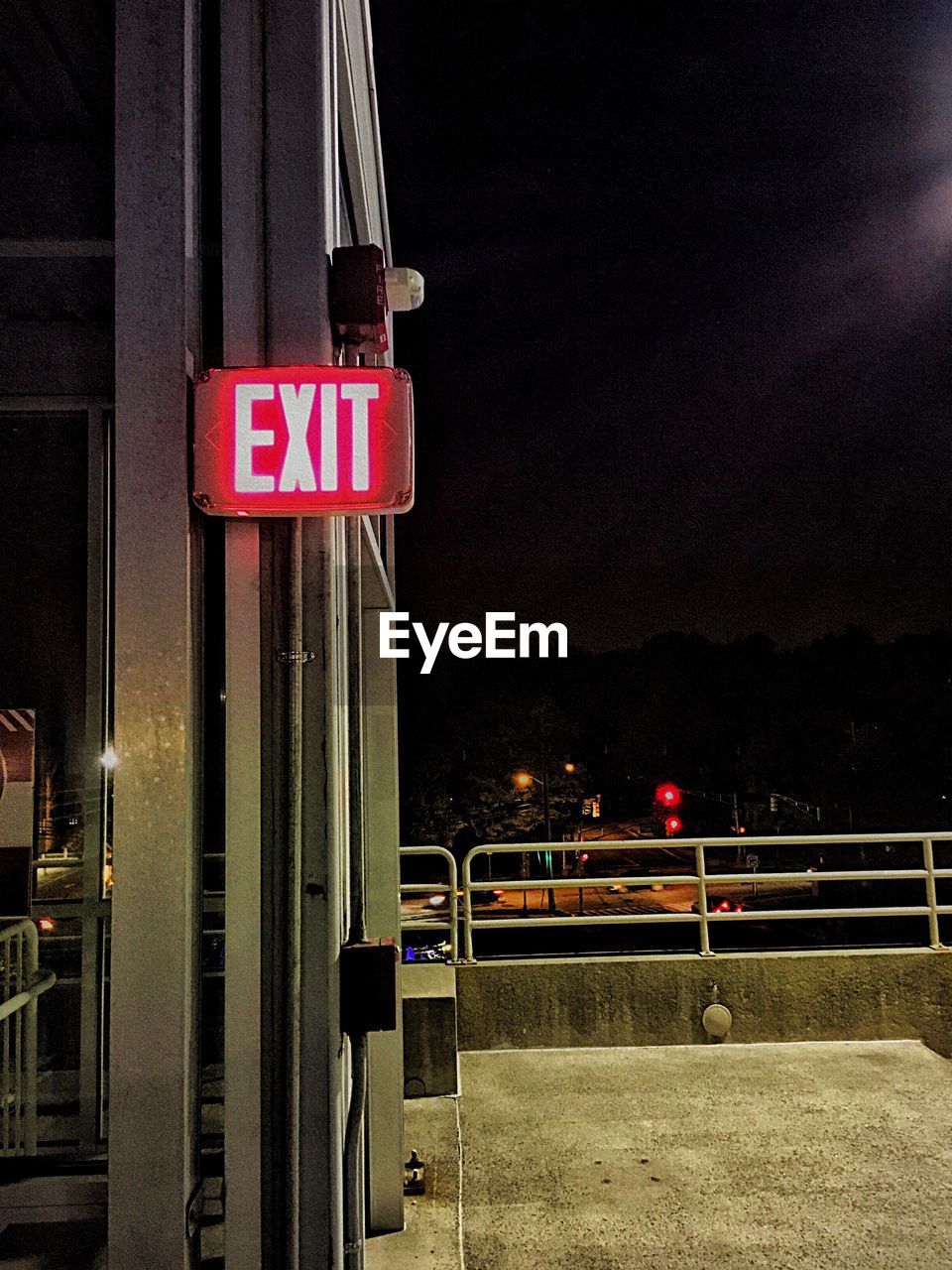 ILLUMINATED ROAD SIGN AGAINST SKY