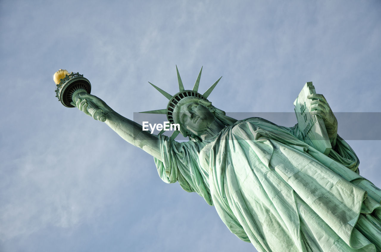 Low angle view of statue of liberty against sky