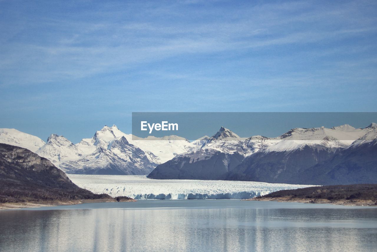 Scenic view of snowcapped mountains and lake against sky