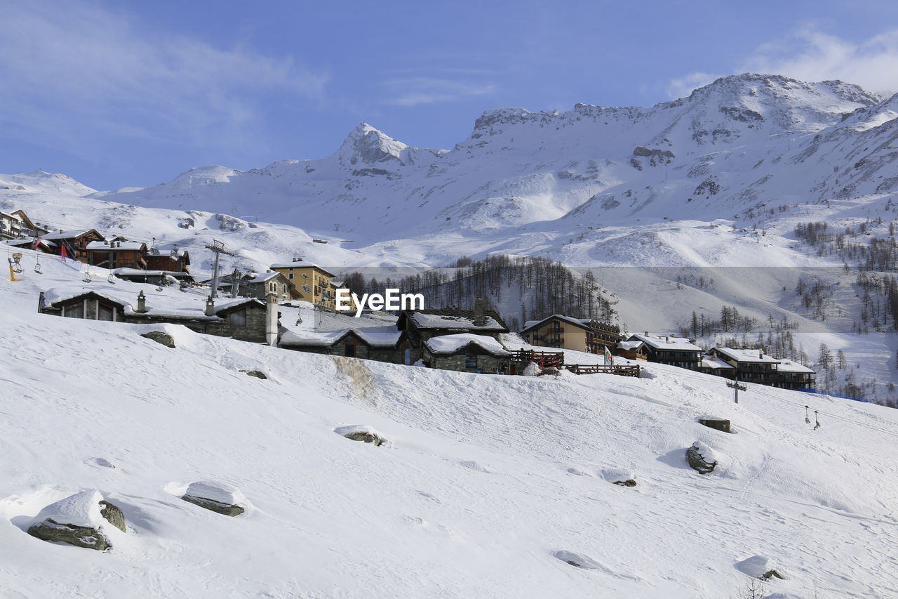 Scenic view of snow covered mountains against sky