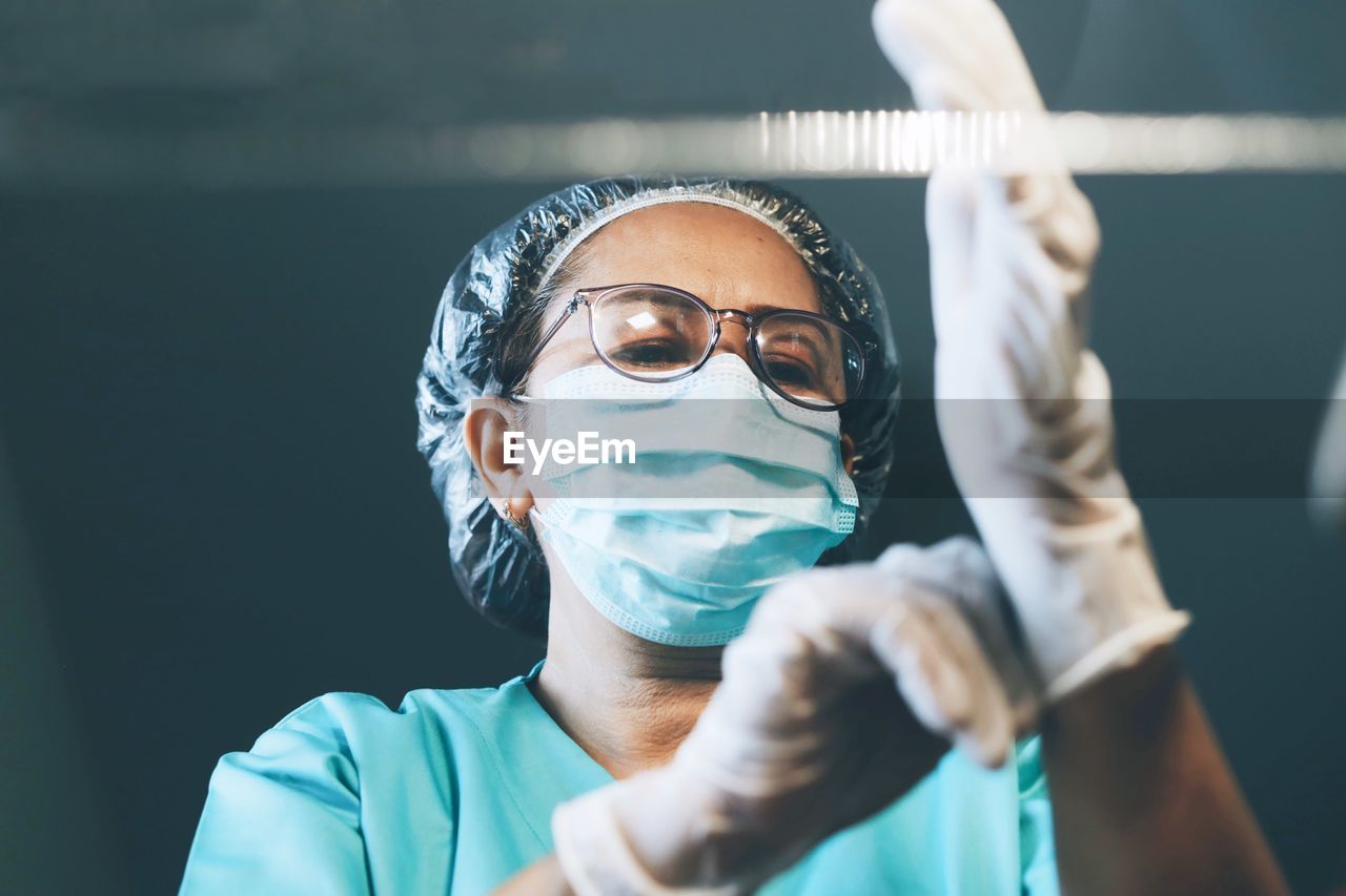 Close-up of surgeon wearing glove