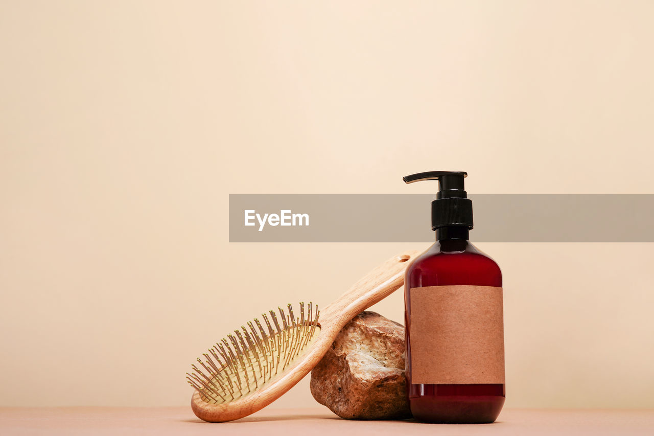 Brown bottle with pump mock up, used for shampoo or conditioner for hair and wood comd 