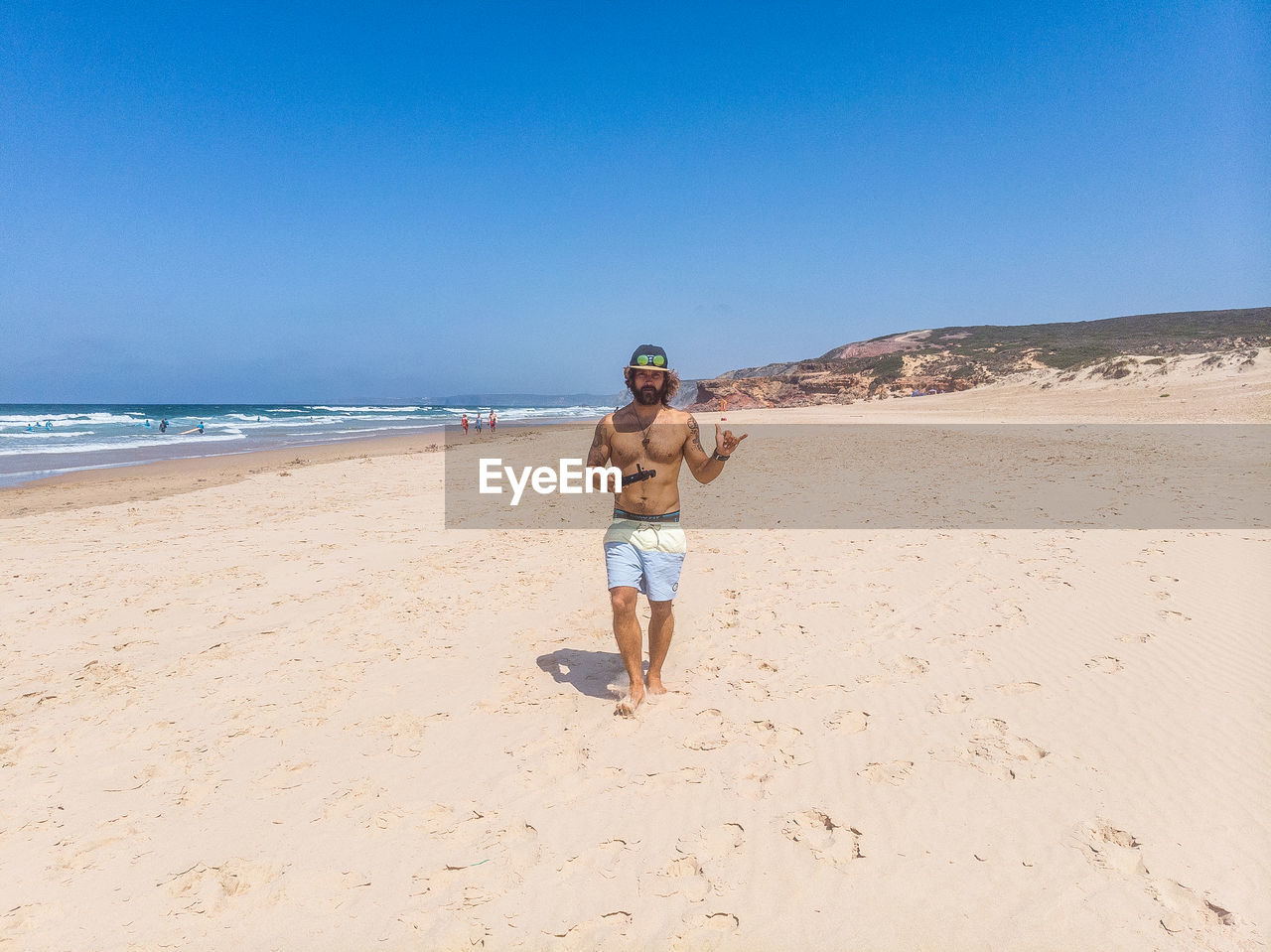 Full length of man on beach against clear sky