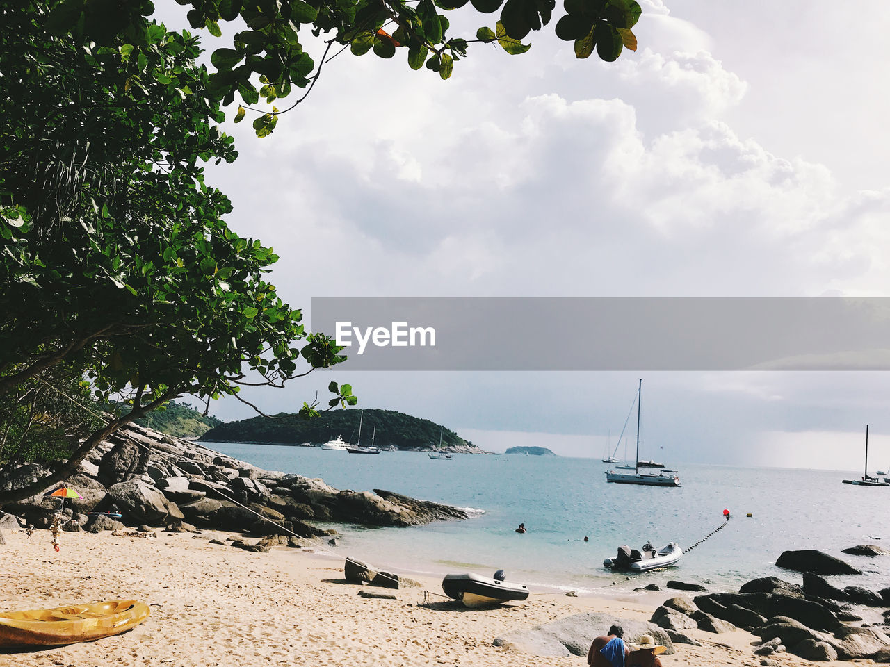 SAILBOATS ON BEACH AGAINST SKY