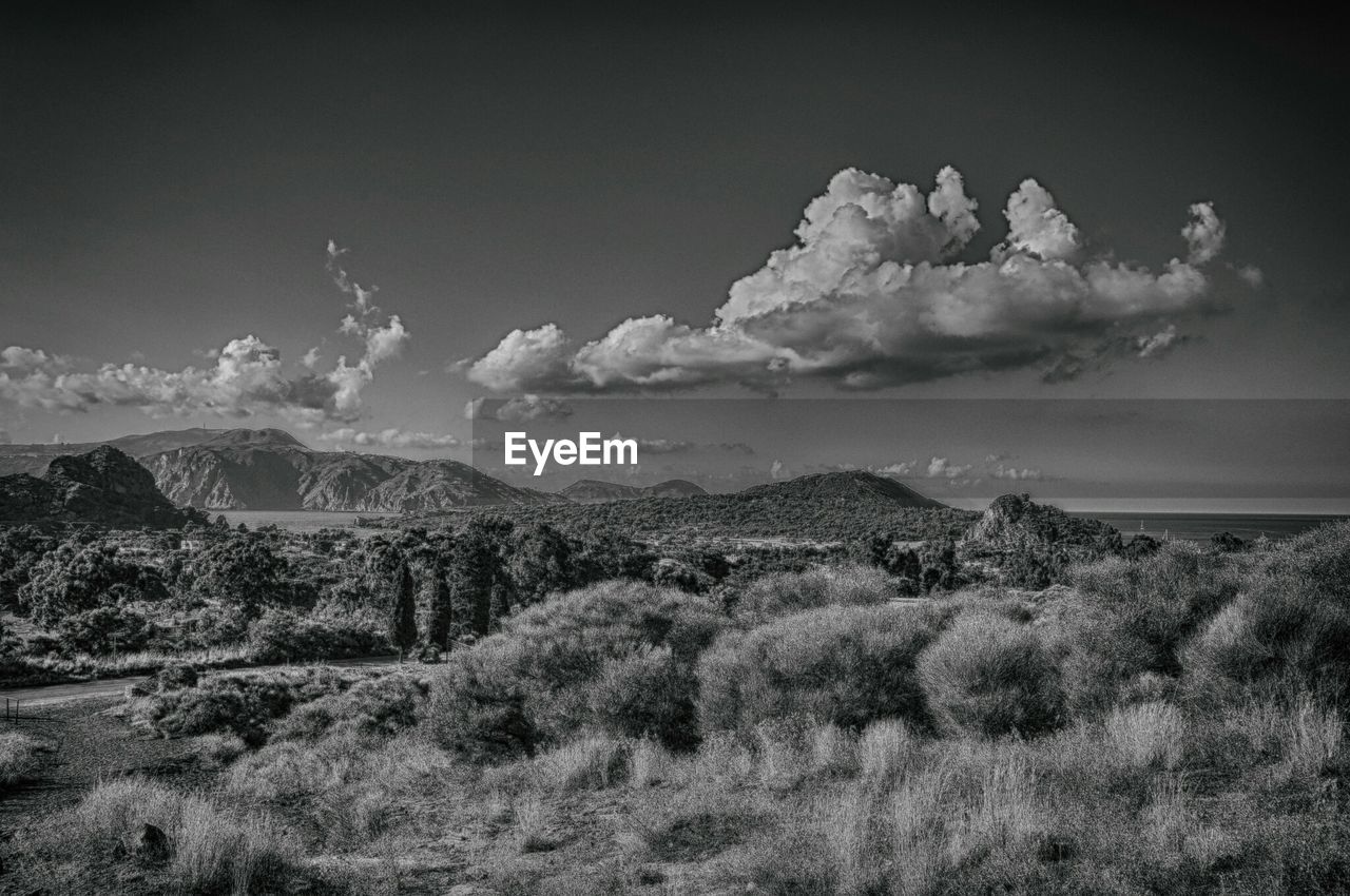 Scenic view of landscape against cloudy sky