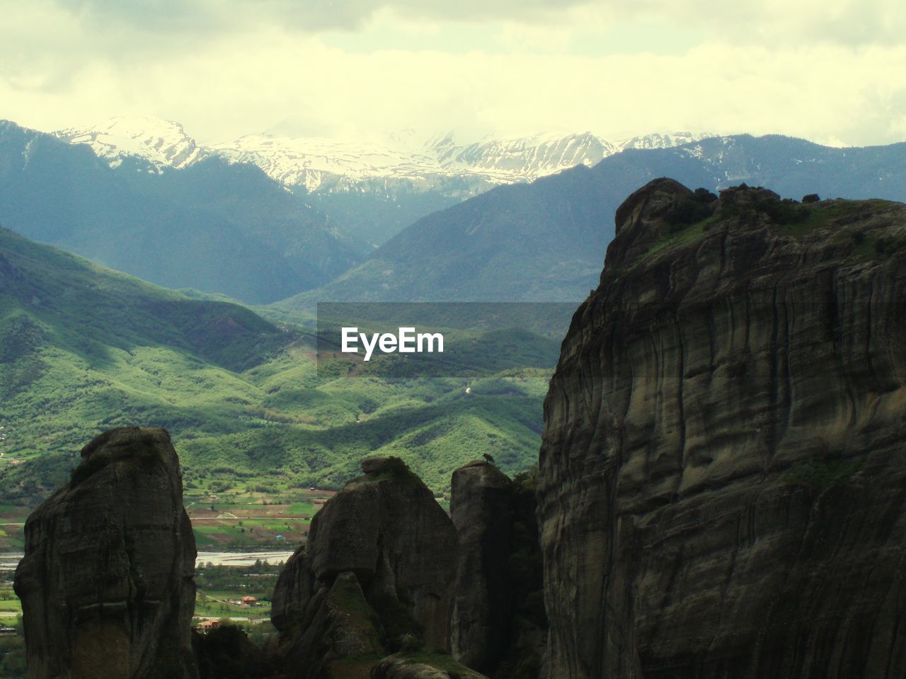 Scenic view of mountains against cloudy sky