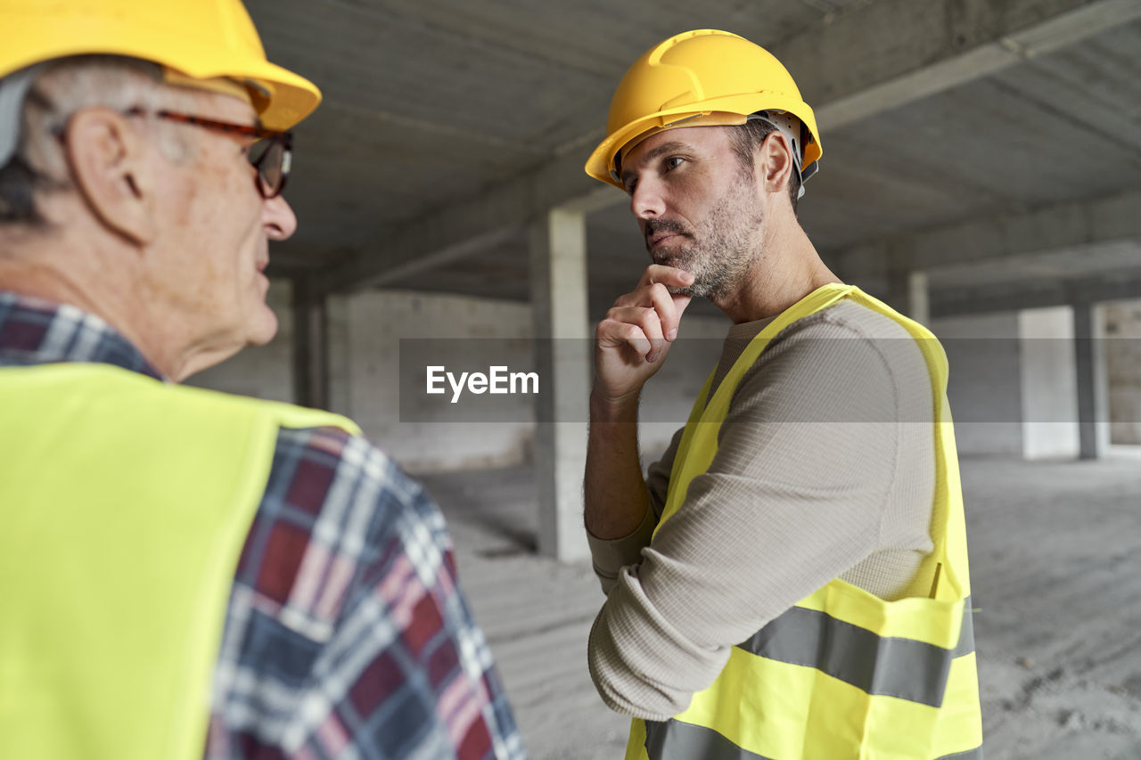 Engineers having discussion at construction site