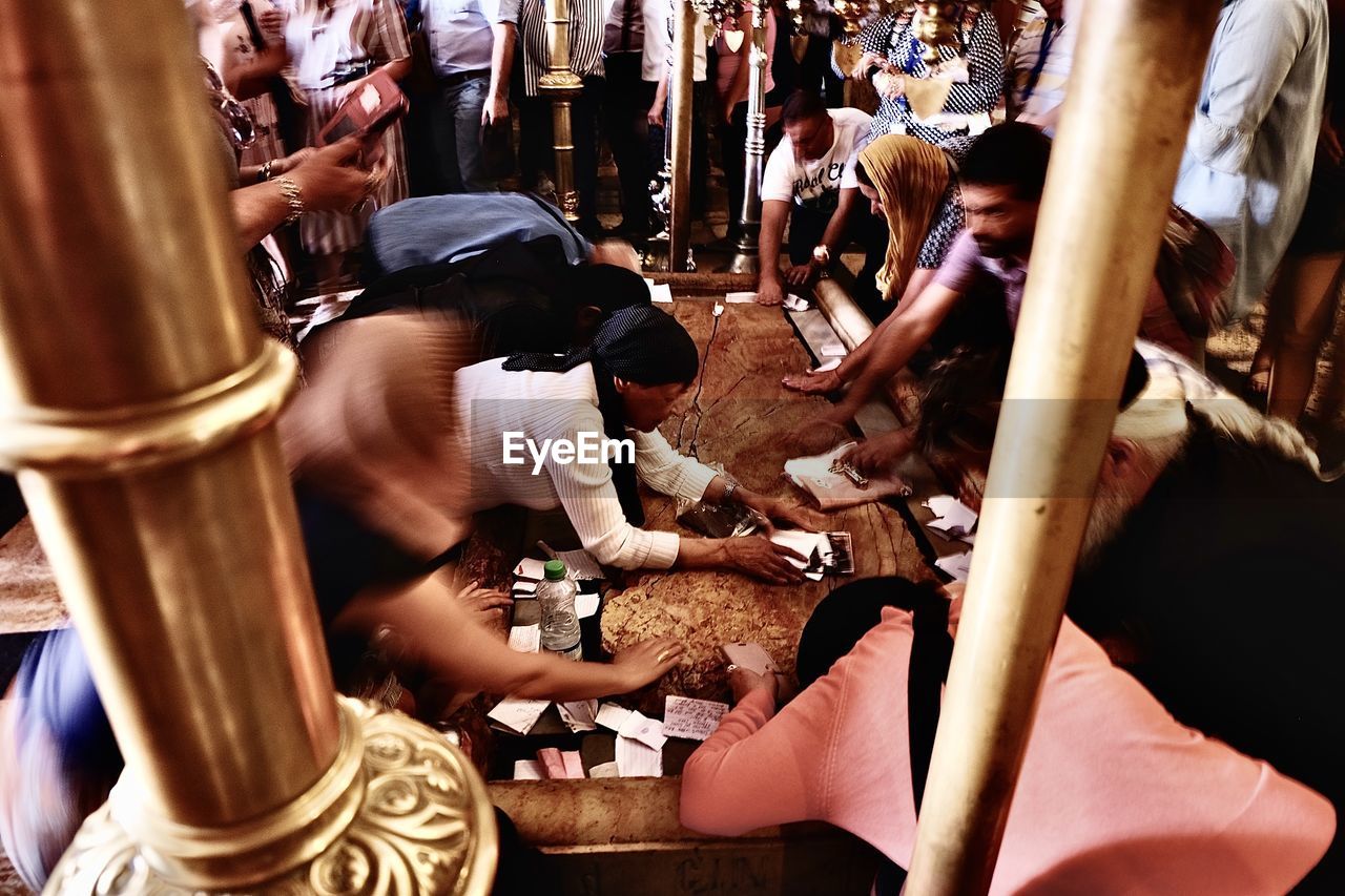 HIGH ANGLE VIEW OF PEOPLE ON STREET