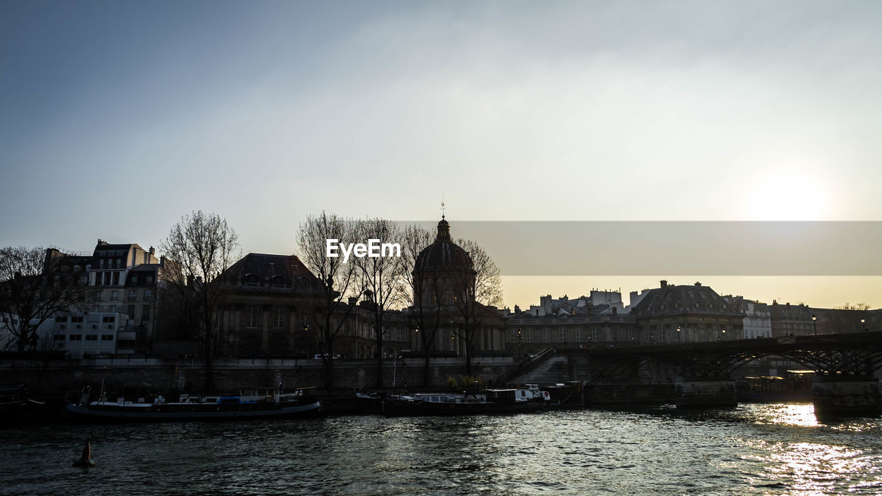 Buildings in city at sunset