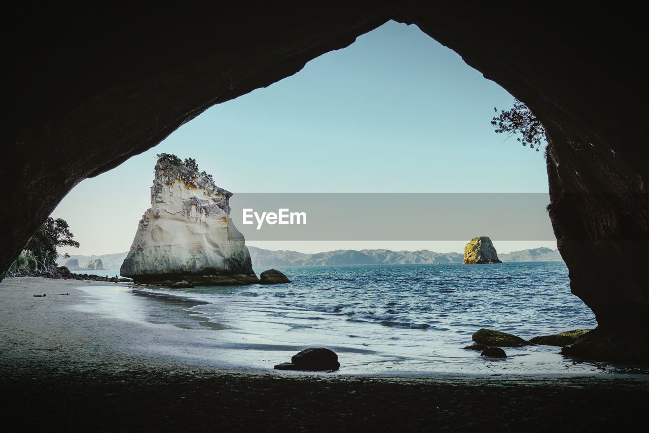 SCENIC VIEW OF SEA WITH MOUNTAIN IN BACKGROUND