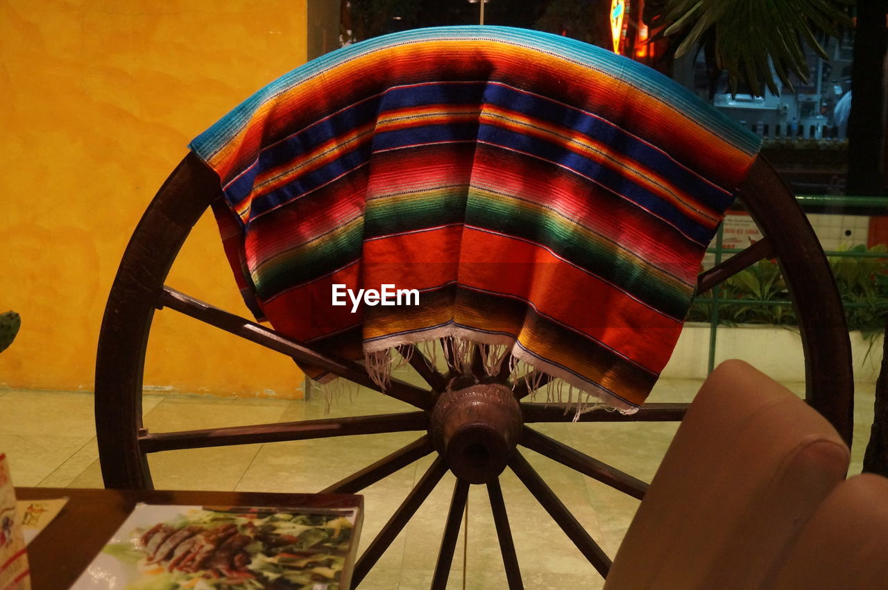 Multi colored fabric on cart wheel