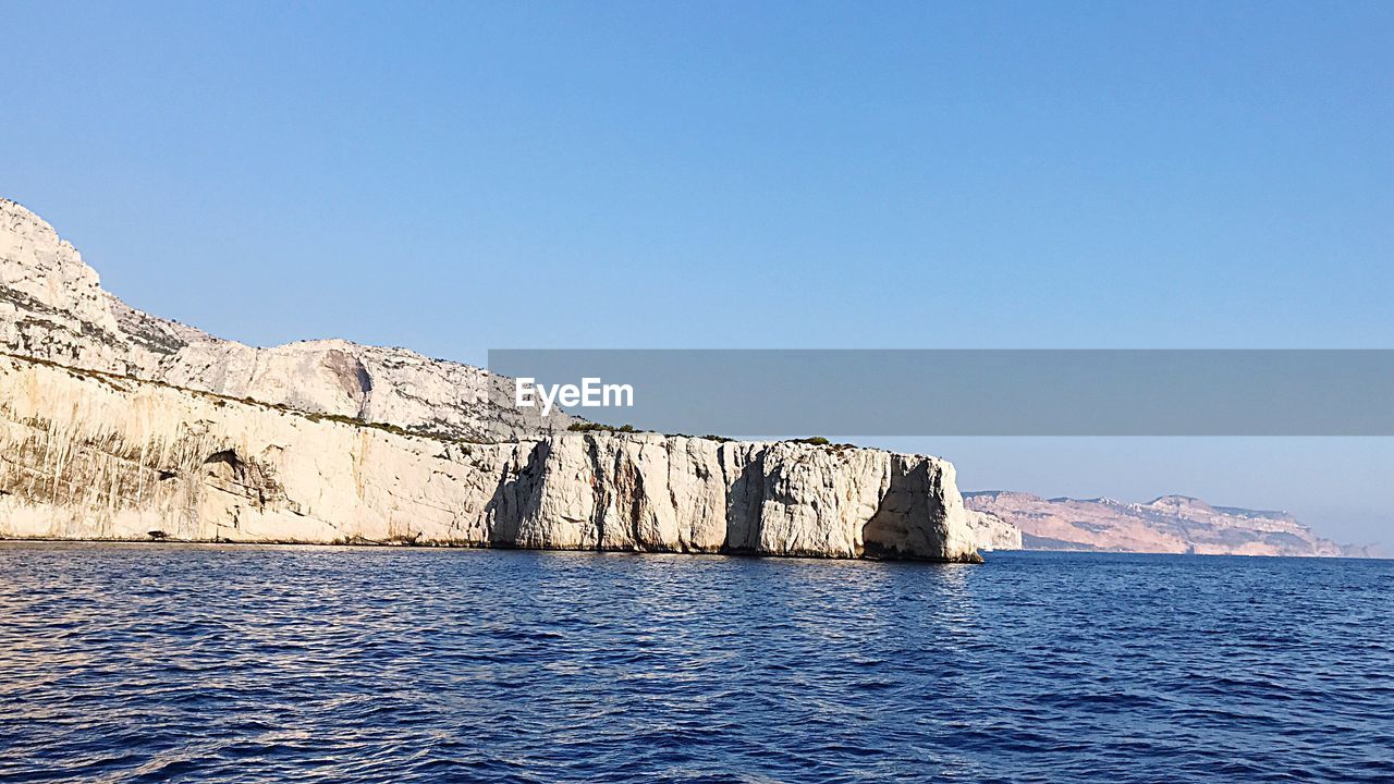 Scenic view of sea against clear blue sky