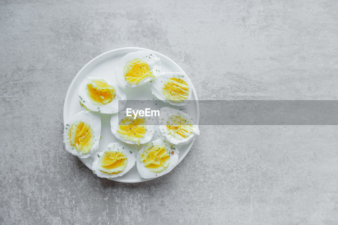 yellow, food and drink, food, healthy eating, freshness, gray background, flower, egg, wellbeing, directly above, gray, high angle view, no people, indoors, studio shot, egg yolk, still life, white, plate, copy space, fruit