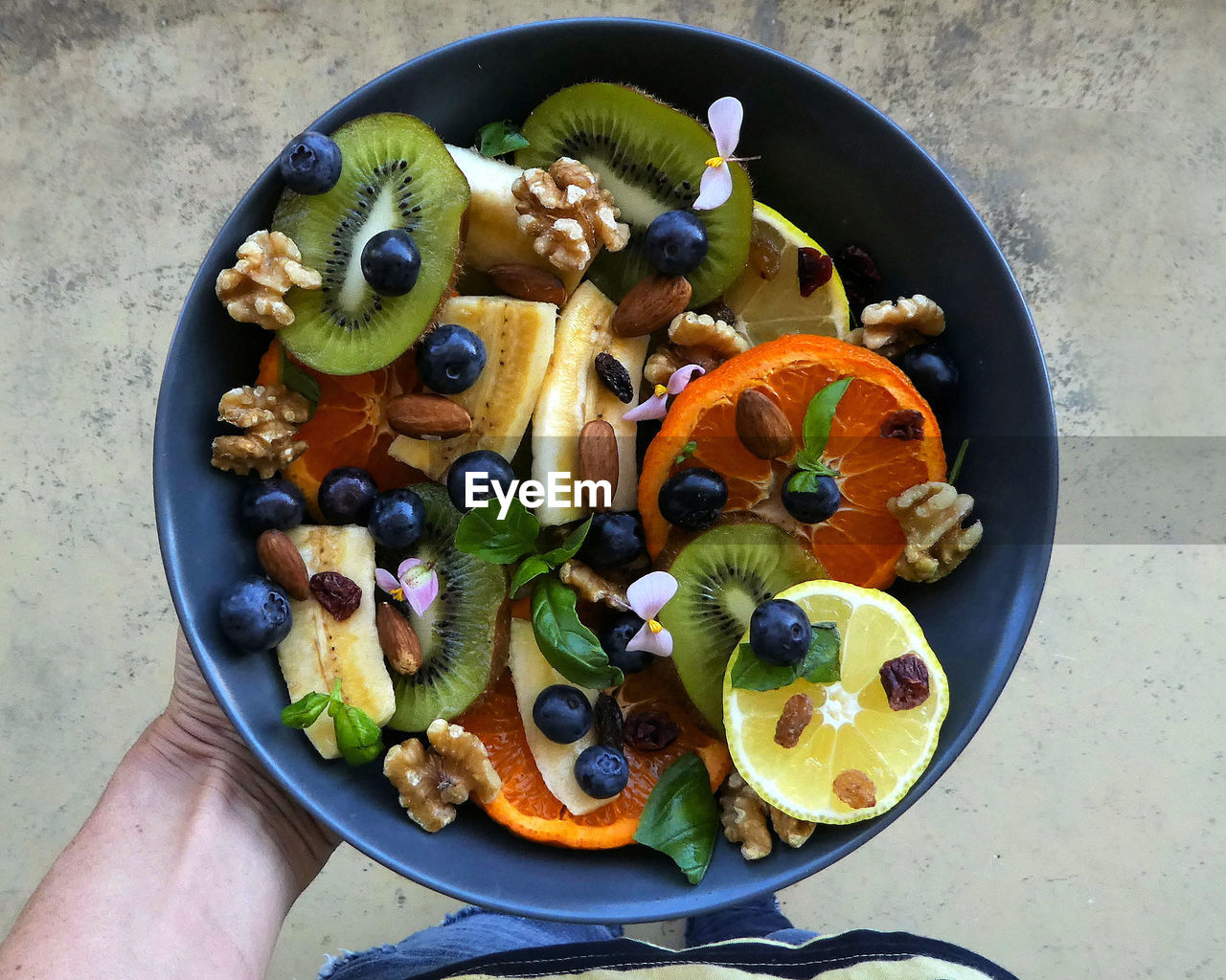 High angle view of hand holding healthy food in bowl