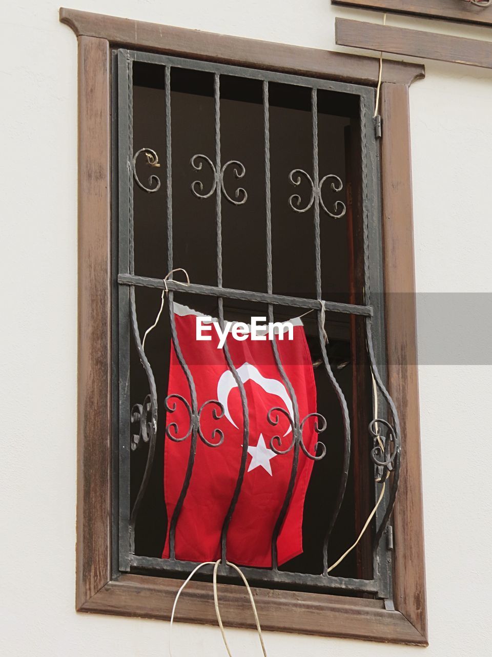 Turkish flag hanging from barred window