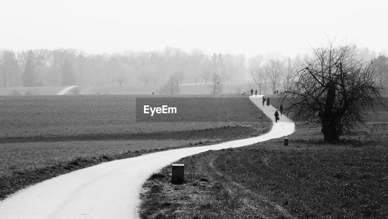 SCENIC VIEW OF ROAD AMIDST FIELD AGAINST SKY