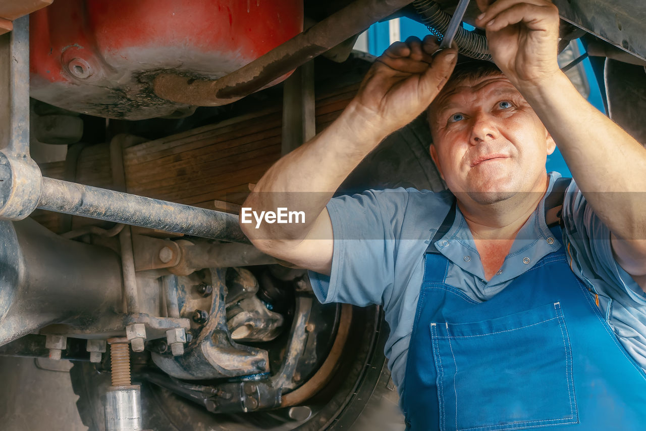 portrait of senior man working at workshop