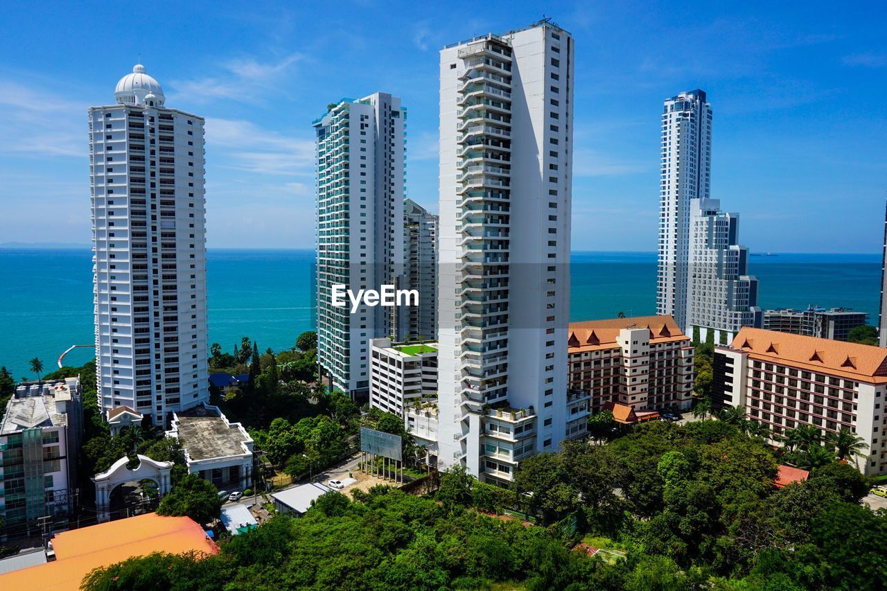 MODERN BUILDINGS BY SEA AGAINST SKY