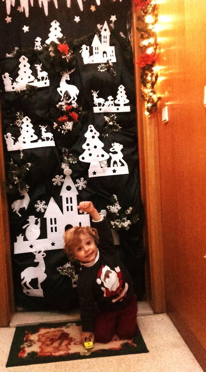 PORTRAIT OF GIRL WITH DOG ON CHRISTMAS TREE IN ROOM