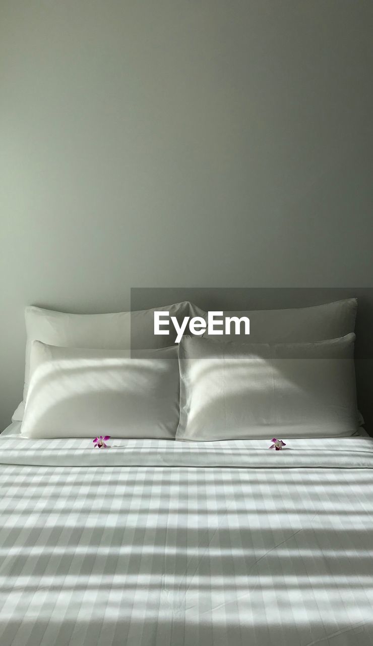 Close-up of empty bed in bedroom