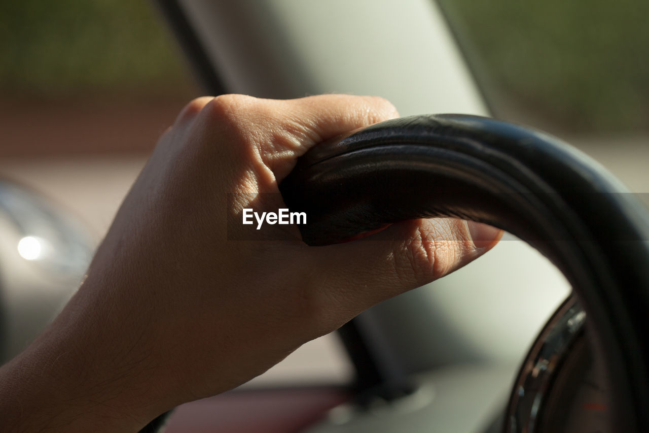 CLOSE-UP OF HAND WITH CAR