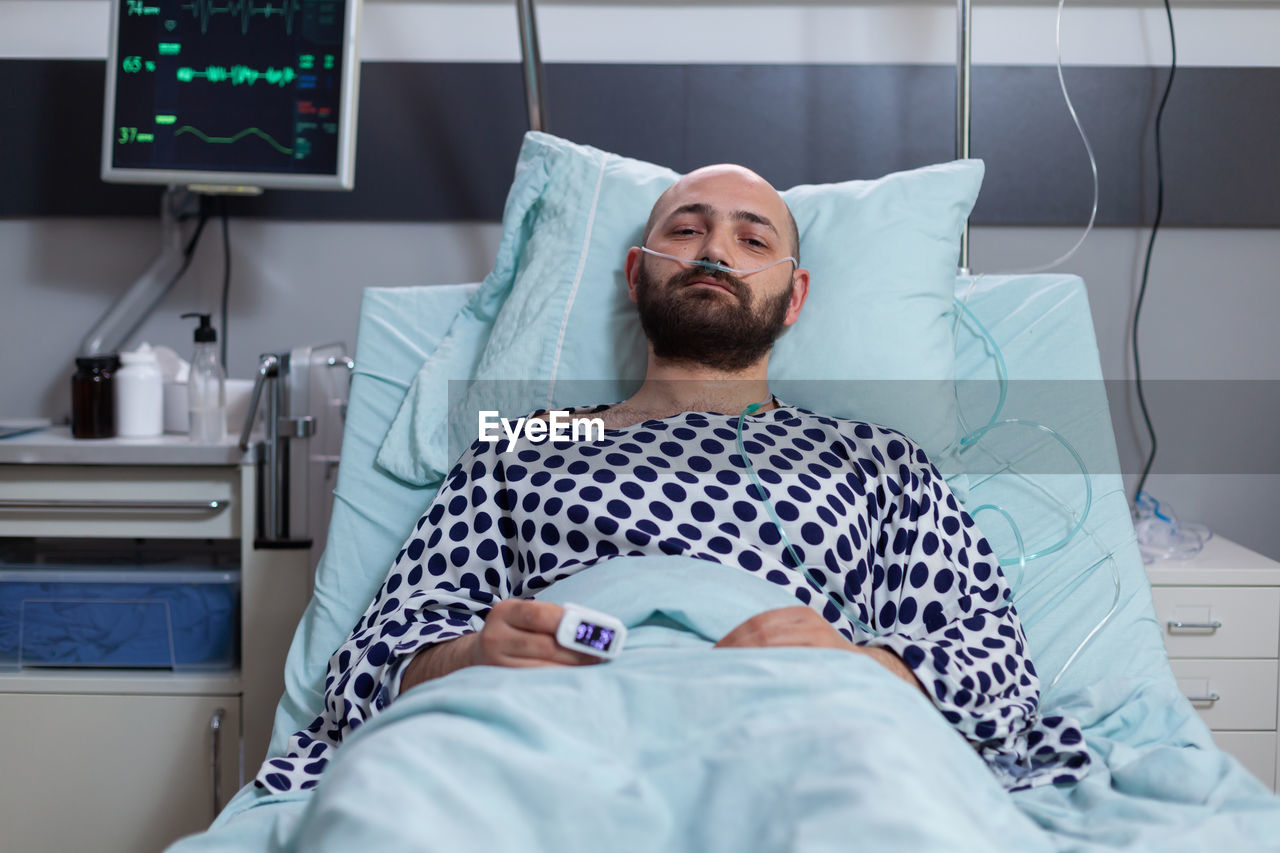 High angle view of young woman sleeping on bed at home