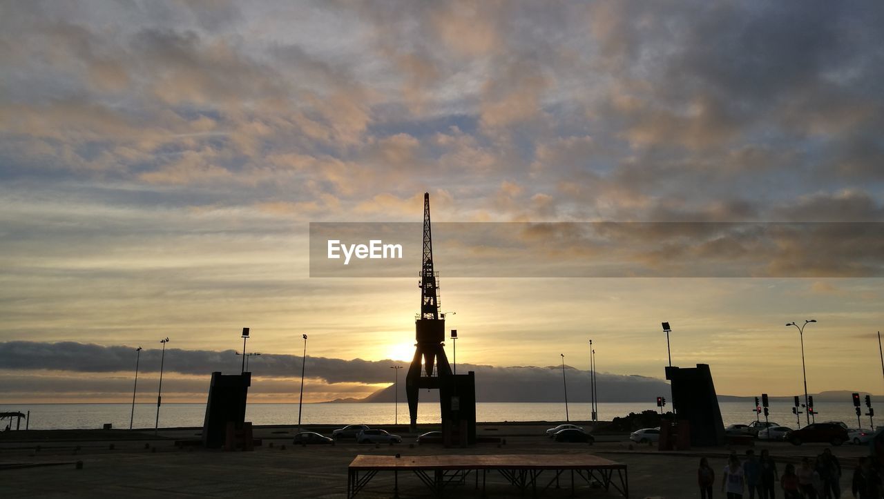 SILHOUETTE COMMERCIAL DOCK AGAINST SKY DURING SUNSET