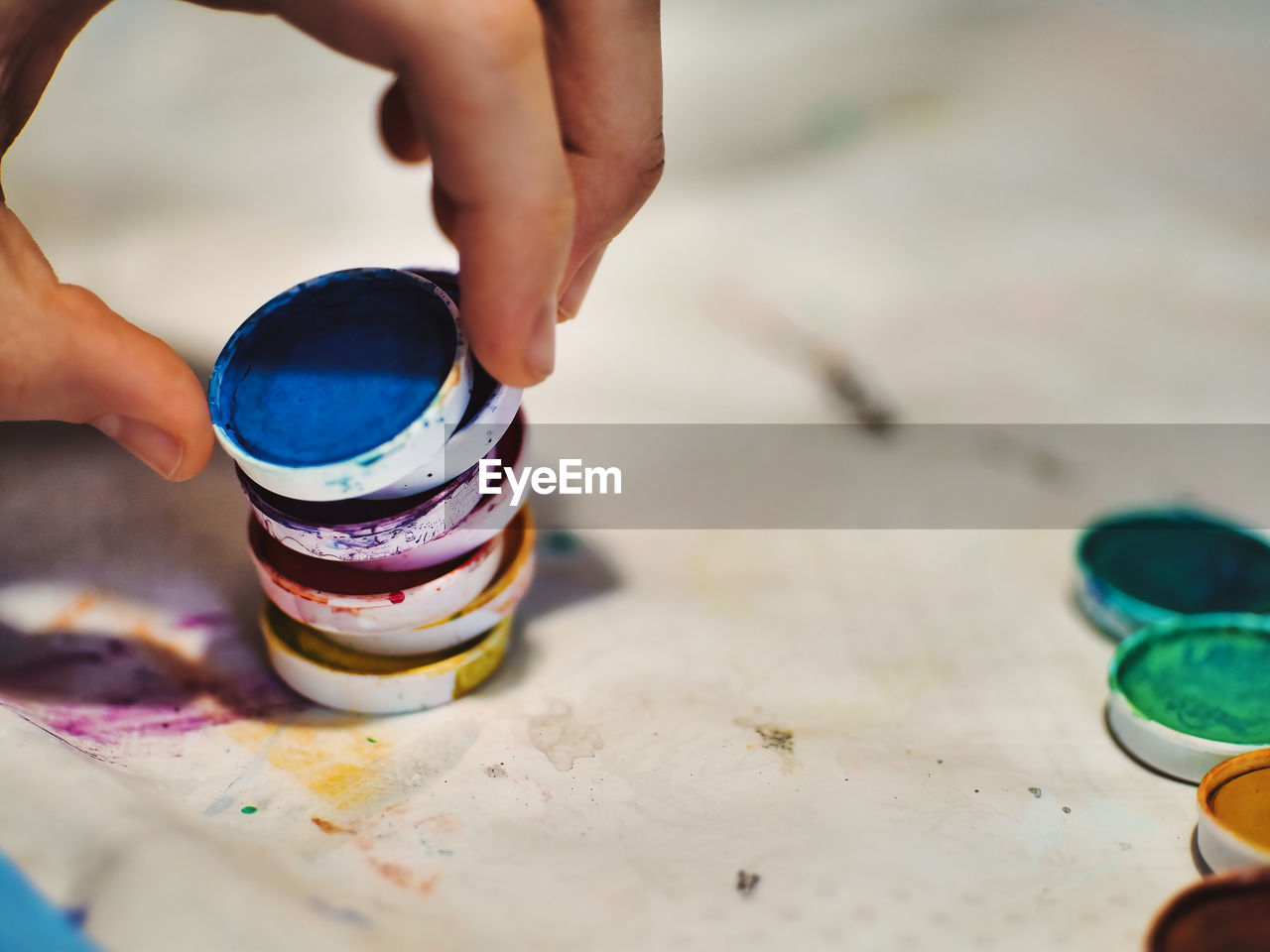one person, hand, brush, paint, creativity, paintbrush, art, multi colored, craft, indoors, child, adult, childhood, palette, women, lifestyles, spring, selective focus, blue, close-up, skill, holding, art and craft equipment