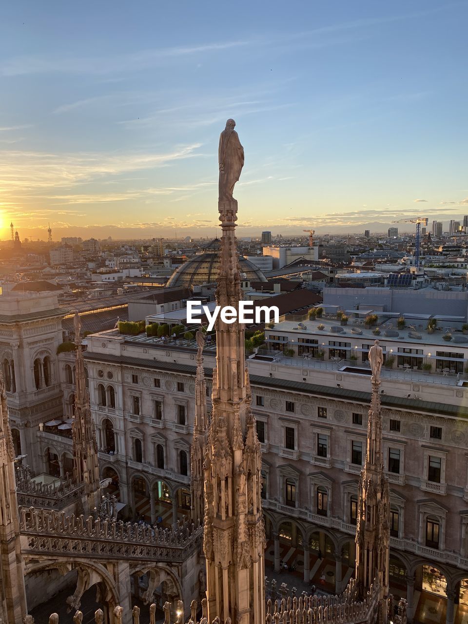 Statue of milano duomo against sky during sunset
